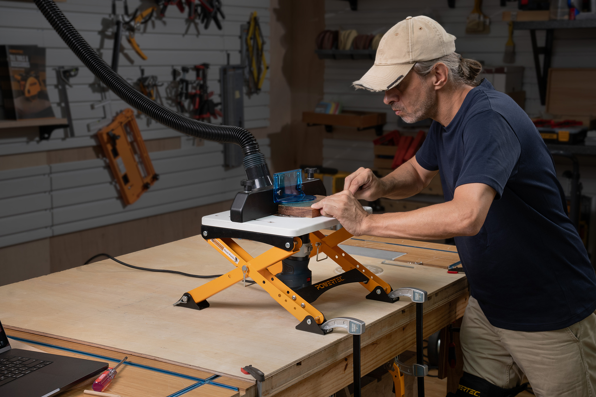 POWERTEC UT1013 folding router table stand set up in a compact workshop