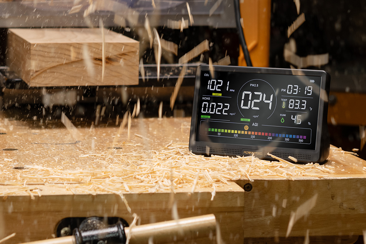 air quality monitor detecting sawdust particles in a woodworking shop