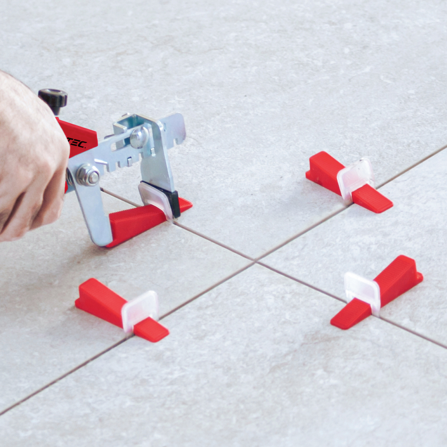 Tile leveling clips and wedges ensuring flush alignment on large-format tile installation.