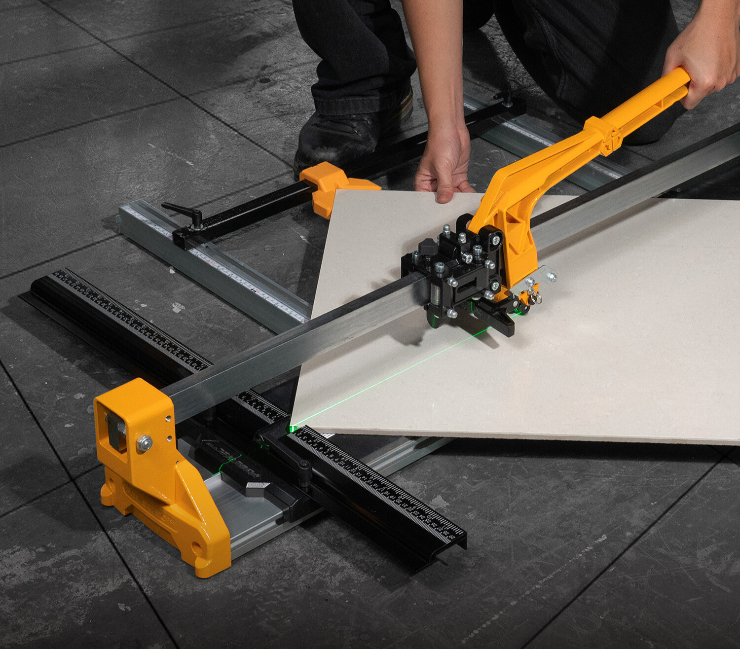 A close-up shot of a Powertec manual tile cutter with a tile being positioned on the base for a straight cut.